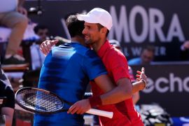 Serbia’s Novak Djokovic, right, hugs Chile’s Alejandro Tabilo after their match at the Italian Open tennis tournament in Rome [Alessandra Tarantino/AP Photo]