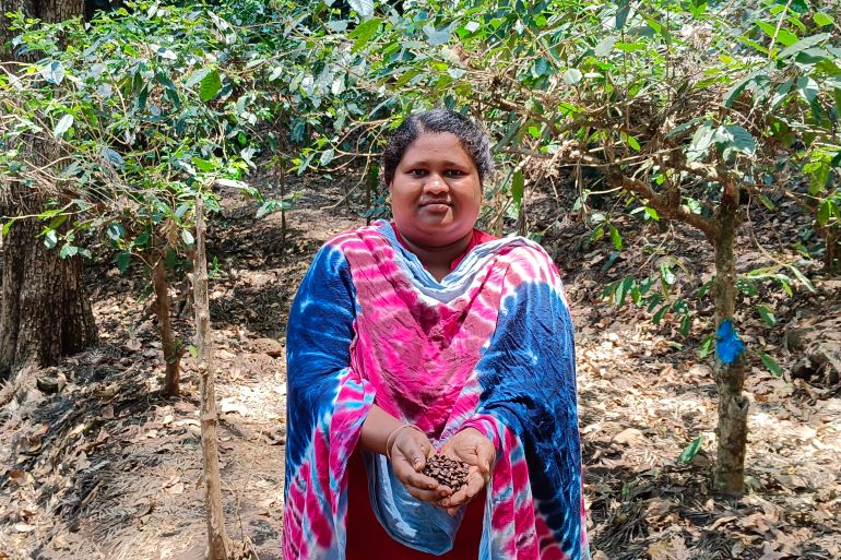 Araku Valley farmer Nava Roja holding coffee beans that originate on her land, but that fetch her less than 1 percent of what they are sold for i the international export market [Gurvinder Singh/Al Jazeera]
