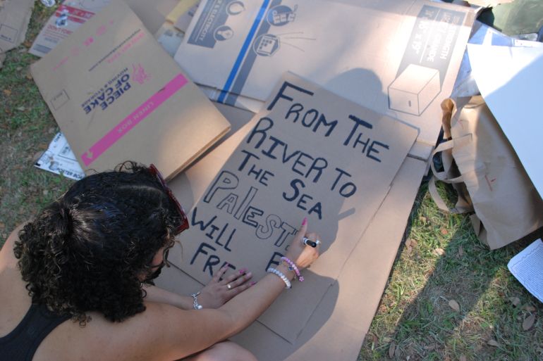 A protester at Tulane University's solidarity encampment makes a sign supporting Palestine on April 30
