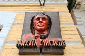 The bronze portrait of novelist Mikhail Bulgakov, doused with red paint for his alleged criticism of Ukraine [Mansur Mirovalev/Al Jazeera]