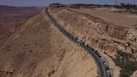 Drone footage captured a long line of aid trucks bound for Gaza stuck on a narrow mountain pass after being blocked by Israeli activists.