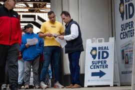 A worker checks documents as Illinois residents enter the Real ID Super Center operated by the Secretary of State&#039;s office to apply for a Real ID on May 6, 2025 in Chicago, Illinois [File: Scott Olson/Getty Images via AFP]